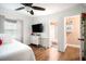 Bedroom with ensuite bathroom, wood floors, and a ceiling fan at 8451 Duncan St, Douglasville, GA 30134