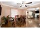 Dining area with a wood table, chairs, and a view into the living room with hardwood floors at 8451 Duncan St, Douglasville, GA 30134