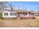Charming home with a stone and siding exterior, covered porch, and rocking chairs at 8451 Duncan St, Douglasville, GA 30134