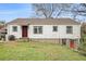 Charming white home with red door, stone foundation, and grassy yard at 8451 Duncan St, Douglasville, GA 30134