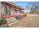 Front porch with steps, rocking chairs, and a stone and siding exterior at 8451 Duncan St, Douglasville, GA 30134