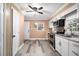 A galley-style kitchen with white cabinets, stainless steel appliances, and a door to the exterior at 8451 Duncan St, Douglasville, GA 30134