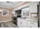 Bright kitchen with white cabinets, stainless steel appliances, and granite countertops at 8451 Duncan St, Douglasville, GA 30134