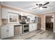 Updated kitchen featuring stainless steel appliances, white cabinetry, and wood-look flooring at 8451 Duncan St, Douglasville, GA 30134