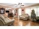 Living room with two sofas, hardwood floors, a decorated Christmas tree, and a dining area at 8451 Duncan St, Douglasville, GA 30134