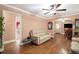 Living area with hardwood floors, sofas, a ceiling fan, and an archway leading to another room at 8451 Duncan St, Douglasville, GA 30134