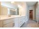 Modern bathroom with double vanity, large mirror, and walk-in closet at 7640 Homer Dr, Cumming, GA 30028