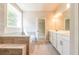 Spacious bathroom with tile floor, double vanity, and a soaking tub at 7640 Homer Dr, Cumming, GA 30028