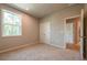 Bedroom with double closet doors, carpeted flooring, and neutral paint at 7640 Homer Dr, Cumming, GA 30028