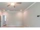 Large, carpeted bedroom with a ceiling fan, doorway, and neutral walls at 7640 Homer Dr, Cumming, GA 30028