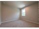 Cozy bedroom with large window, neutral walls, and carpeted flooring at 7640 Homer Dr, Cumming, GA 30028