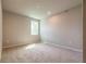 Empty bedroom with neutral walls, carpeting, and a single window at 7640 Homer Dr, Cumming, GA 30028