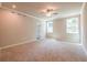Spacious bedroom with carpet, ceiling fan, and multiple windows at 7640 Homer Dr, Cumming, GA 30028