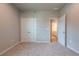 Bedroom featuring carpeted flooring, closet doors, and neutral paint at 7640 Homer Dr, Cumming, GA 30028