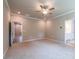 Spacious bedroom with carpet, a ceiling fan, and doorways to other rooms at 7640 Homer Dr, Cumming, GA 30028