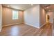 Bonus room with wood floors, neutral paint, and adjacent bathroom access at 7640 Homer Dr, Cumming, GA 30028