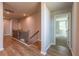 Hallway with wood-look flooring, a staircase and black railing, and door to another room at 7640 Homer Dr, Cumming, GA 30028
