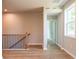 Hallway with wood-look flooring, a staircase with black railing, and a window at 7640 Homer Dr, Cumming, GA 30028