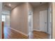 Empty hallway with hardwood floors and doors leading to rooms at 7640 Homer Dr, Cumming, GA 30028