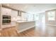 Modern kitchen with white cabinets, island, stainless appliances, and open floor plan at 7640 Homer Dr, Cumming, GA 30028