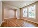 Spacious living room with hardwood floors and large windows at 7640 Homer Dr, Cumming, GA 30028