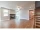 Living room with fireplace, wood floors, and ceiling fan at 7640 Homer Dr, Cumming, GA 30028