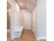 Mudroom with built-in bench, hooks, and access to a nearby bathroom at 7640 Homer Dr, Cumming, GA 30028