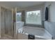 Bathroom with a walk-in shower and soaking tub at 1721 Cobblefield Cir, Dacula, GA 30019
