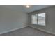 Well-lit bedroom with carpeted floor and window at 1721 Cobblefield Cir, Dacula, GA 30019