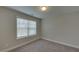 Spacious bedroom with carpeted floor and window with blinds at 1721 Cobblefield Cir, Dacula, GA 30019