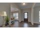 Bright and airy foyer with dark hardwood floors and views to the dining room at 1721 Cobblefield Cir, Dacula, GA 30019