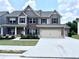 Two-story brick home with a three-car garage and manicured lawn at 1721 Cobblefield Cir, Dacula, GA 30019