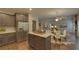 Open kitchen features island and breakfast area, flows into living room at 1721 Cobblefield Cir, Dacula, GA 30019