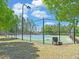 Well-maintained tennis court with a chain-link fence and ample surrounding green space at 1721 Cobblefield Cir, Dacula, GA 30019