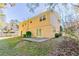 View of the back of a two-story home with a patio and grassy yard at 633 Larchmont Nw Cir, Atlanta, GA 30318
