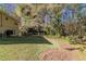Sloped backyard with grassy area and some trees and foliage at 633 Larchmont Nw Cir, Atlanta, GA 30318