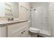 Modern bathroom featuring a white vanity, granite countertop, and marble shower at 633 Larchmont Nw Cir, Atlanta, GA 30318
