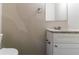 Compact bathroom with white vanity, granite countertop, and a simple mirror at 633 Larchmont Nw Cir, Atlanta, GA 30318