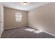 Empty bedroom with neutral walls, carpeting, and a single window at 633 Larchmont Nw Cir, Atlanta, GA 30318