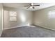 Spacious bedroom with neutral walls, carpeting, and a ceiling fan at 633 Larchmont Nw Cir, Atlanta, GA 30318