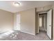 Empty bedroom with neutral walls, plush carpet, and a door leading to another room at 633 Larchmont Nw Cir, Atlanta, GA 30318