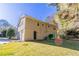 View of the back of a two-story house featuring a garage, patio, and grassy yard at 633 Larchmont Nw Cir, Atlanta, GA 30318