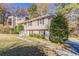 Two-story home with a red door and a landscaped front yard at 633 Larchmont Nw Cir, Atlanta, GA 30318