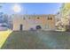 Backyard view of a two-story house with a small patio and grassy yard at 633 Larchmont Nw Cir, Atlanta, GA 30318