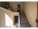 Split-level entryway with carpeted stairs, wood-look flooring, and metal railing at 633 Larchmont Nw Cir, Atlanta, GA 30318