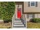 Red front door with a glass panel, white railing, and shrubs at 633 Larchmont Nw Cir, Atlanta, GA 30318