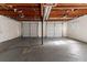 Two-car garage with white doors and a concrete floor at 633 Larchmont Nw Cir, Atlanta, GA 30318