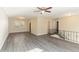 Open living room with wood-look floors, ceiling fan, and a view of the staircase at 633 Larchmont Nw Cir, Atlanta, GA 30318