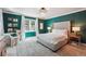 Spacious bedroom with teal walls, a comfortable bed, and a cozy armchair at 1900 Harper Nw Rd, Atlanta, GA 30318
