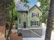 Charming two-story green house with black shutters and a brick staircase at 1900 Harper Nw Rd, Atlanta, GA 30318